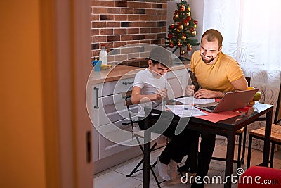 Father helping son to do homework Stock Photo