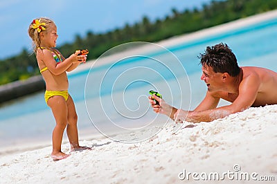 Father and his daughter on exotic beach Stock Photo