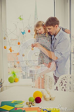 Father and his daughter painting and decorating easter eggs. Stock Photo