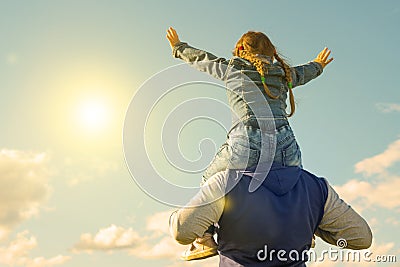 Father and his daughter playing outdoors. the child sits at the daddy on the neck, Stock Photo