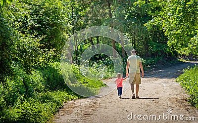 Father and his little daughther walking hand in hand together on Editorial Stock Photo