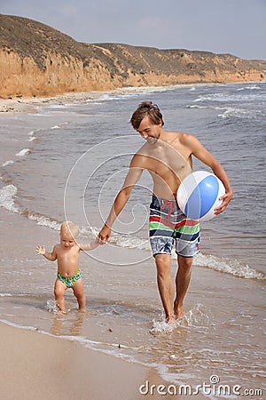 Father and his son on the beach Stock Photo