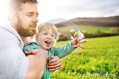 A father with his toddler son outside in spring nature. Stock Photo