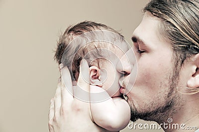 Father with his young baby cuddling and kissing him on cheek Stock Photo