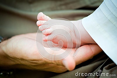 Father holding a baby girl foot Stock Photo