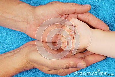 Father is holding babys hand Stock Photo