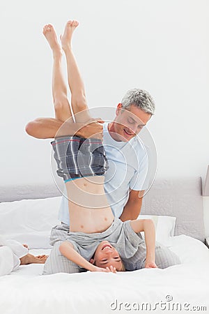 Father holding his son upside down Stock Photo