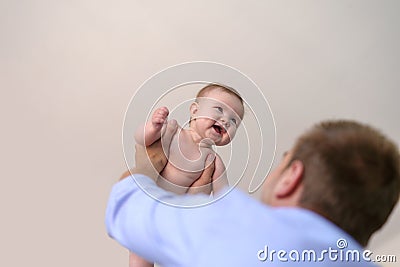 Father holding little baby girl aloft Stock Photo