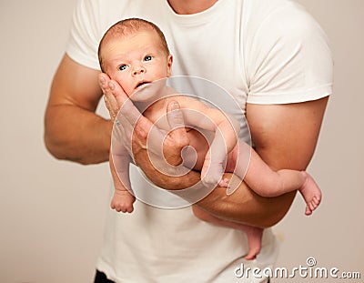 Father holding new born baby on his arm Stock Photo