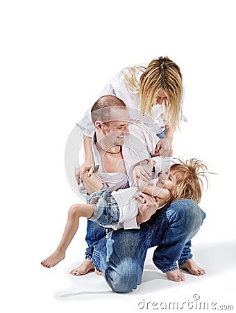 Father holds daughter and mother bends over them Stock Photo