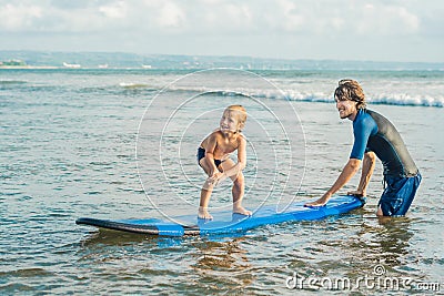 Father or instructor teaching his 4 year old son how to surf in the sea on vacation or holiday. Travel and sports with Stock Photo