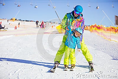 Father or instructor teaching little skier how to make turns Stock Photo