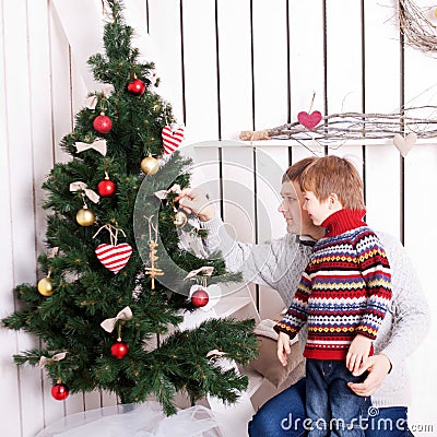 Father and kid decorating the Christmas tree Stock Photo