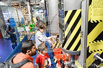 Father and kids in Science Center museum Nemo, Amsterdam, experiments with water Editorial Stock Photo