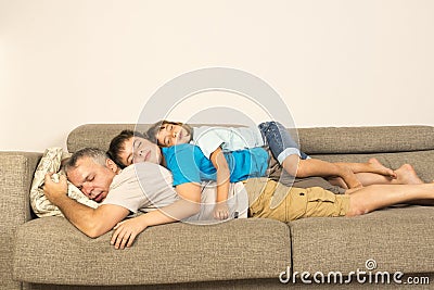 Father and kids sleeping on the sofa Stock Photo