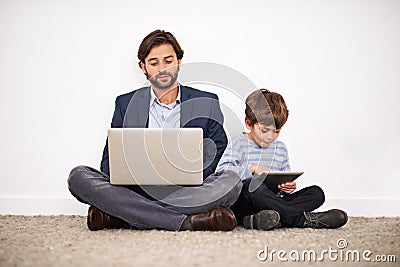 Father, laptop and kid with tablet on floor for learning, online education and relax at home. Child, dad and computer Stock Photo