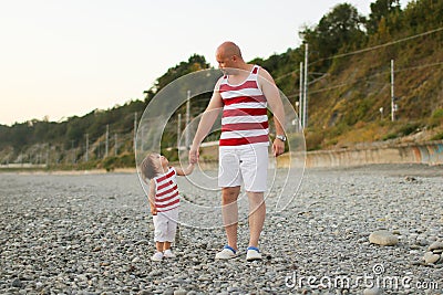 Father and little son in similar clothes look at together Stock Photo