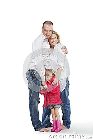 Father, mother and daughter stand embraced Stock Photo