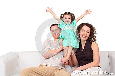 Father, mother and daughter on white leather sofa Stock Photo