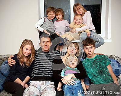 Father, mother and seven children at home. Stock Photo