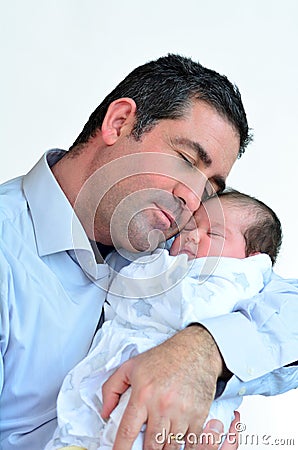 Father and newborn baby kissing and hugging. Stock Photo
