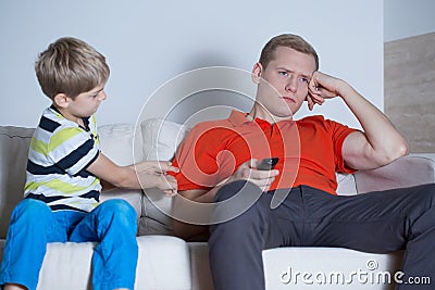 The father is not interested in his son Stock Photo