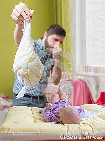 Father od dad is changing diaper that smell. Baby care concept Stock Photo