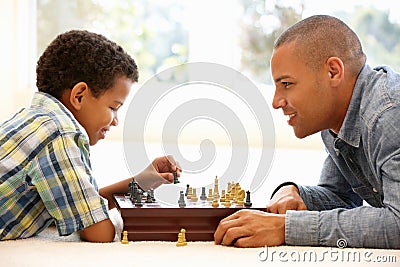 Father playing chess with son Stock Photo