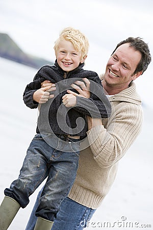 Father playing with son at beach Stock Photo