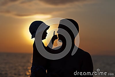 Father plays with son against a sunset Stock Photo