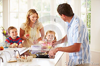 Father Preparing Family Breakfast In Kitchen Stock Photo