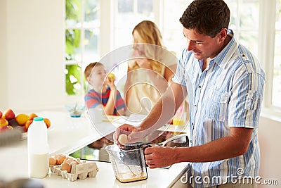 Father Preparing Family Breakfast In Kitchen Stock Photo