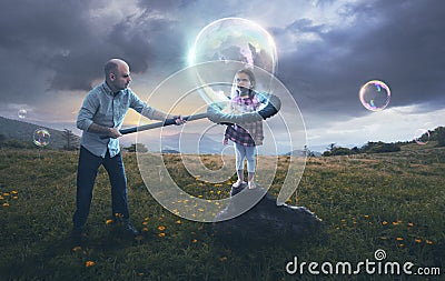 Father putting child in a bubble Stock Photo