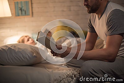 Father Reading Bedtime Story to Son Stock Photo