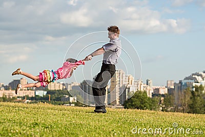 Father rotate girl in Stock Photo