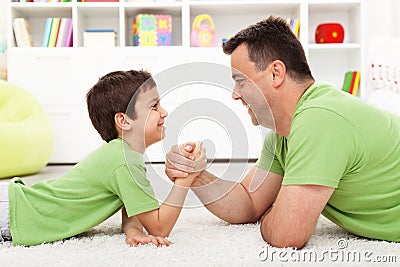 Father and son arm wrestling Stock Photo