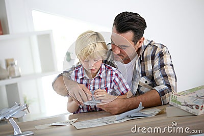 Father and son assembling a plane toy Stock Photo