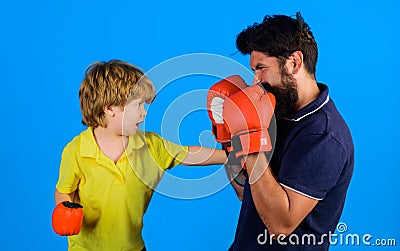 Father and son boxing. Little child boxer with coach at boxing training. Boy and trainer in boxing gloves. Child and Stock Photo