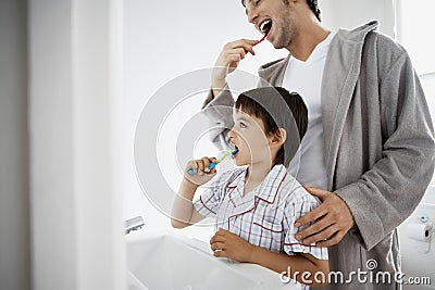 Father And Son Brushing Teeth Stock Photo