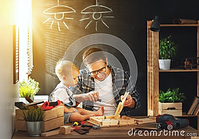 Father and son carved of wood in carpentry workshop Stock Photo