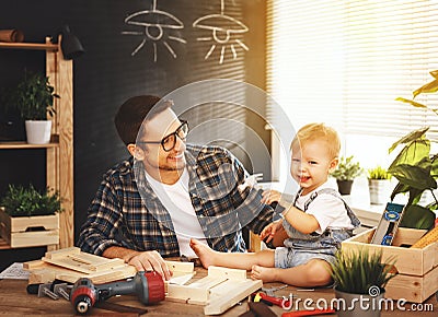 Father and son carved of wood in carpentry workshop Stock Photo