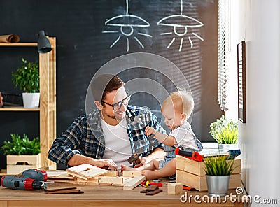Father and son carved of wood in carpentry workshop Stock Photo