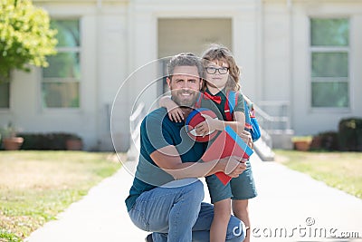 father and son come back from school. happy family values. childhood and parenthood. Stock Photo
