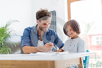 Father and son doing homework together Stock Photo