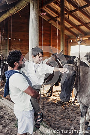 Father and son enjoying a sunny day on a farm Stock Photo