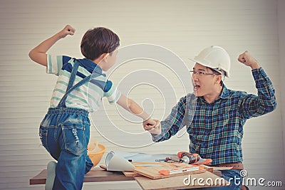 Father Son fist bump for success concept in construction industry concept in vintage tone Stock Photo