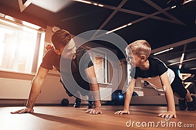 Father and son in the gym. Father and son spend time together and lead a healthy lifestyle. Stock Photo