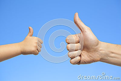 Father and son hands giving like on sky background Stock Photo