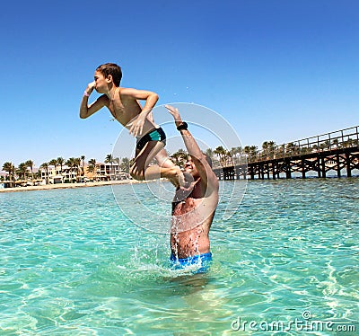 Father and son have fun at sea. Stock Photo