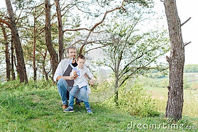 Father and son have fun together in nature. Father and son playing. People having fun outdoors. Concept of friendly family Stock Photo